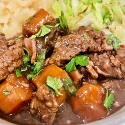 Slow cooker beef bourguignon - close up served with mash